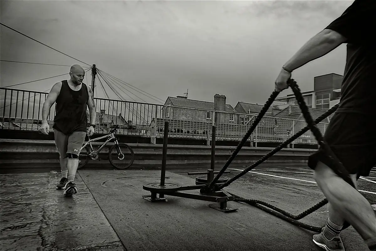 A member training with battle ropes