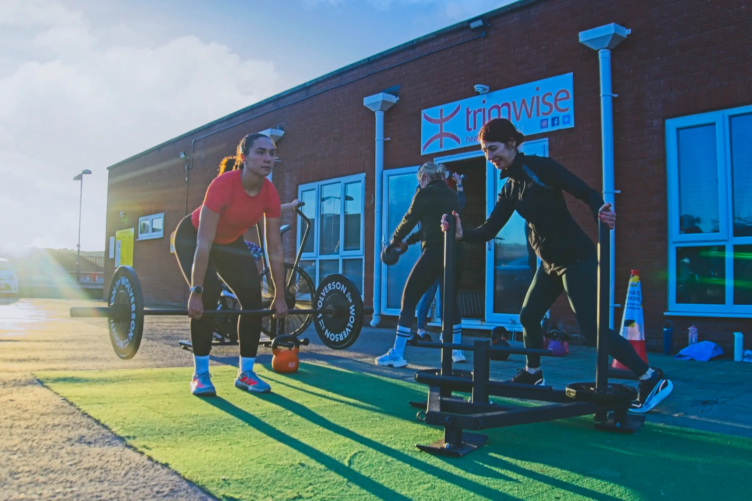 Members training outside the Trimwise building in the evening sun